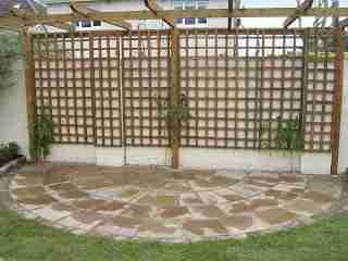 Half moon patio and pergola with wisteria climbers