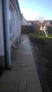 Photo of yellow limestone paving with recessed manhole covers