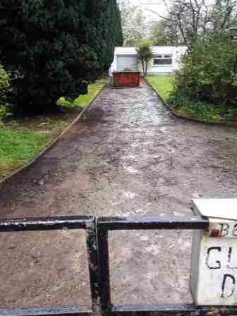 Scraped driveway of dirt and existing loose stones