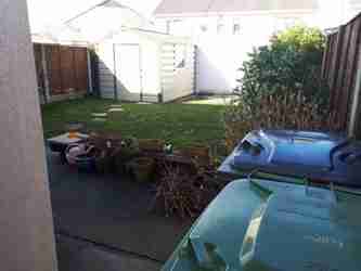images of a undesigned garden lawn and stepping stones and shed