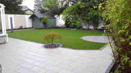 Low Maintenance Garden Design With Silver Granite Flag Paving & Artificial lawn