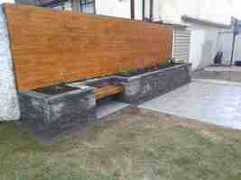 Raised Connemara Walling Bed, Silver Granite Textured Patio & Larch Cladding, Laytown Co.Meath